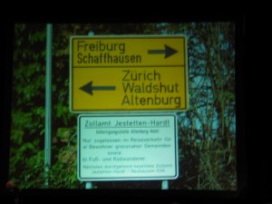 Two highway signs at a border crossing