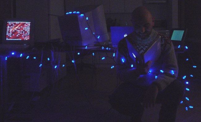 Me among blue-LED Christmas lights and four Macintoshes