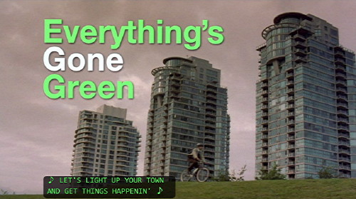 Screenshot shows ‘Everything’s Gone Green’ title in green and white Helvetica type, with Vancouver see-throughs in the background, a bicyclist, and a caption
