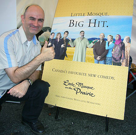 Me giving thumbs-up by ‘Little Mosque’ poster