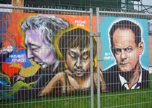 Graffiti-style mural of Margaret Atwood, Michie Mee, and Rex Murphy