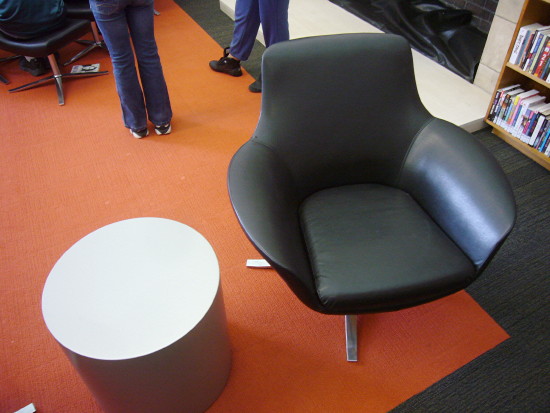 Black chair alongside round table