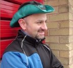 Me in hat standing in front of red wall