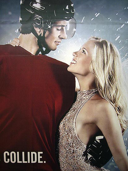 Young male hockey player in plain red jersey stares into the eyes of female figure skater in a sequinned gown