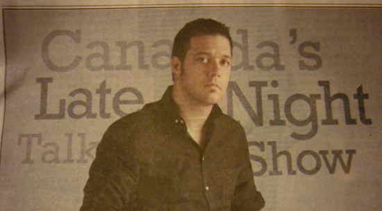 Strombo in front of field reading Canada’s Late Night Talk Show