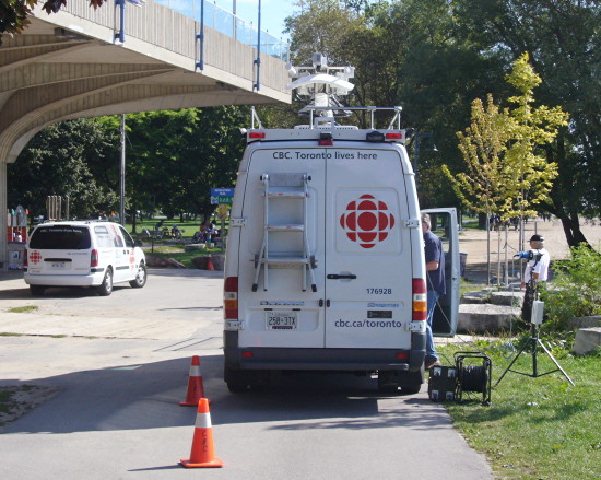 Microwave truck and van. Legend: CBC. Toronto lives here