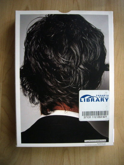 RFID tag stuck boxed item to the right of the back of a man’s head