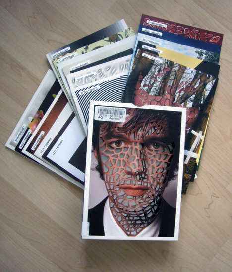 Booklets arranged under box, with cover perforations arranged across Sagmeister’s face