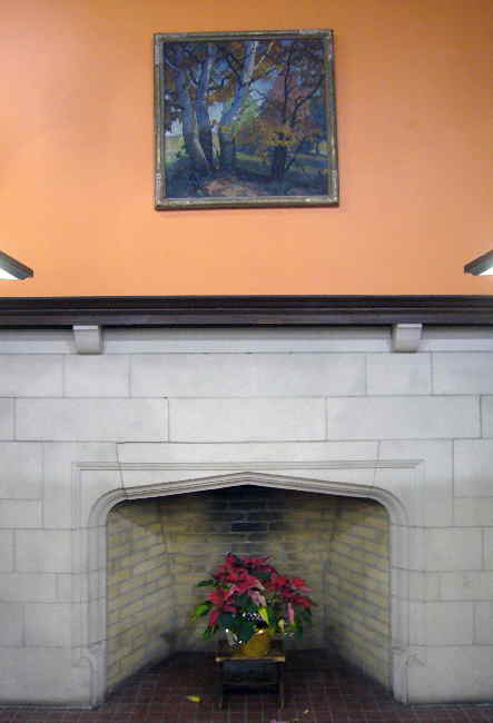 Fireplace contains a poinsettia in its hearth