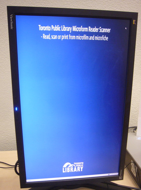 Vertical monitor has two lines of scrunched white type at the top amid a sea of blue