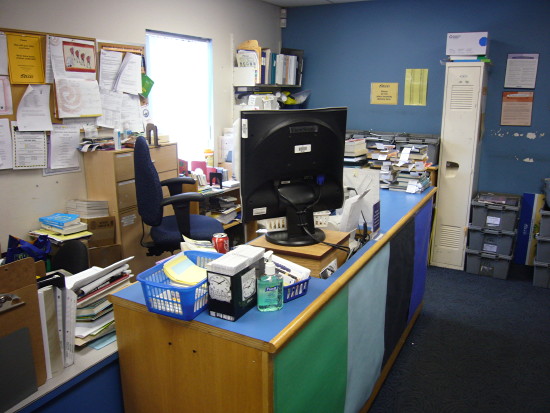 Circulation desk in cluttered corner