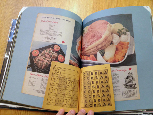 Double-page spread showing four-inch-high kraft ration book bound inside