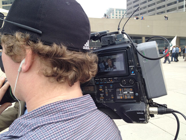 Maureen O’Reilly in viewfinder of news camera