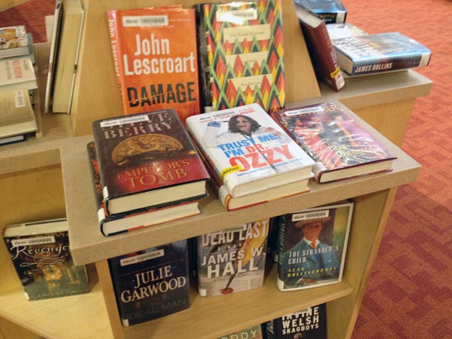 Books on shelf piled face-up