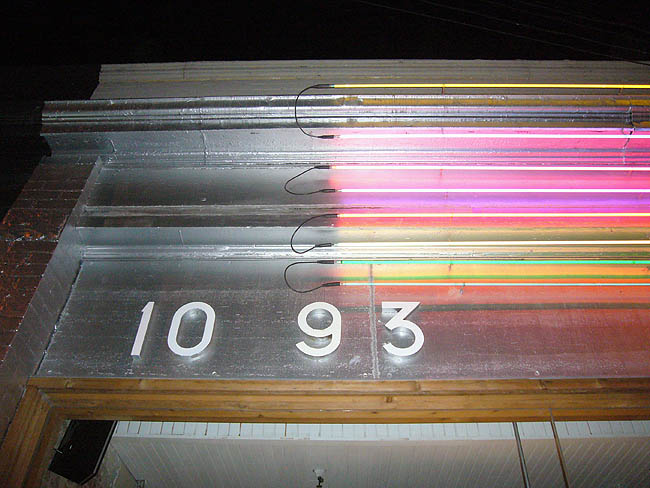 Sign reads 1093 alongside stacked rows of coloured neon tubes