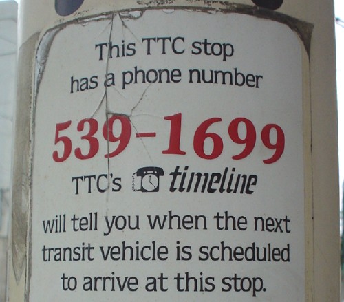 Decal reads ‘This TTC stop has a phone number. 539-1699. TTC’s TimeLine will tell you when the next transit vehicle is scheduled to arrive at this stop’