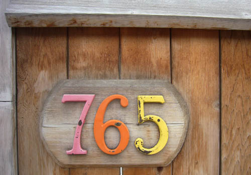 765 in coloured wooden letters on a wooden fence