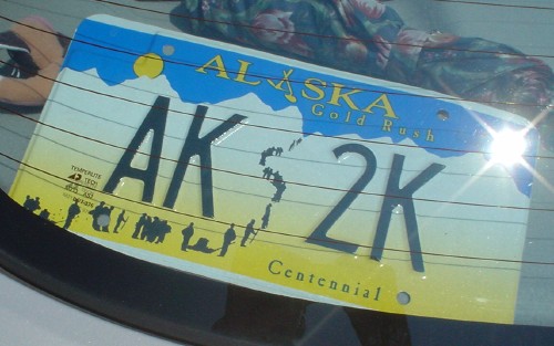 Alaska license plate reads AK 2K and Alaska Gold Rush Centennial