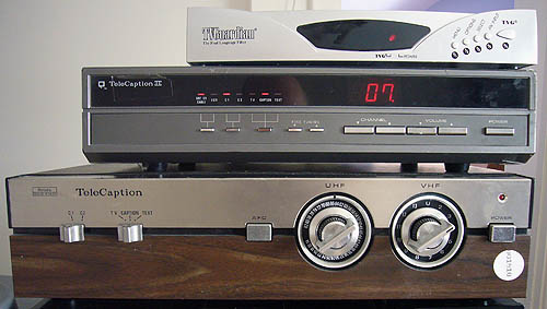 Small silver set-top box, large silver one, huge woodgrain box with rotary dials