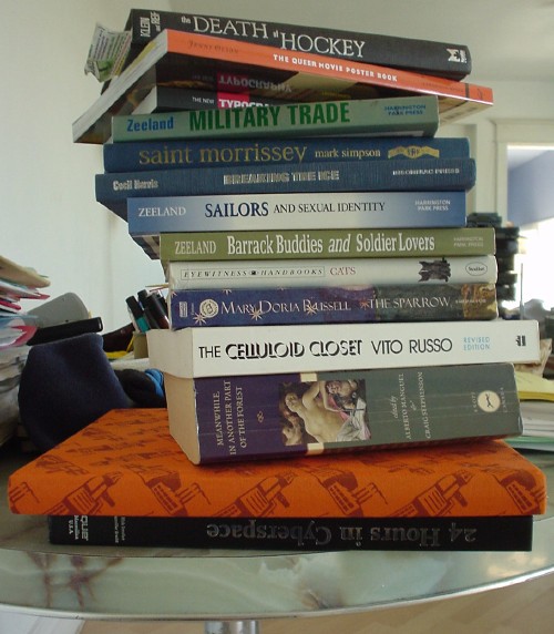 Stack of books on table including ‘The Death of Hockey,’ ‘The Queer Movie Poster Book,’ ‘The New Typography’