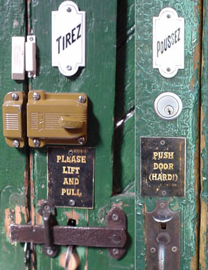 Green doors with wrought-iron handles and hardware