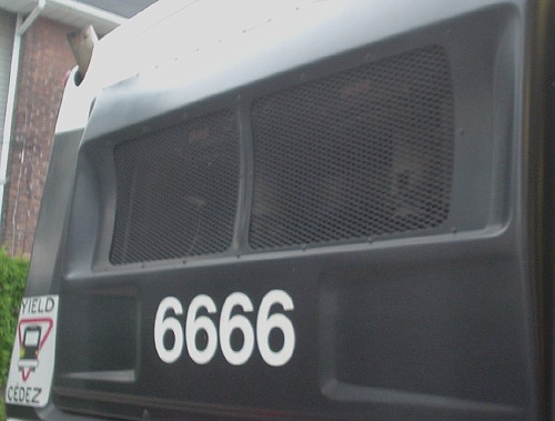 Rear of black bus is labeled with ‘6666’ in Helvetica