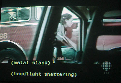 Subtitle reads Shit! as captions, separated by a blank line, read (metal clank) and (headlight shattering)