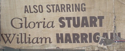 Torn, vintage-like wheatpasted sign reads ALSO STARRING Gloria STUART William HARRIGAN in different fonts