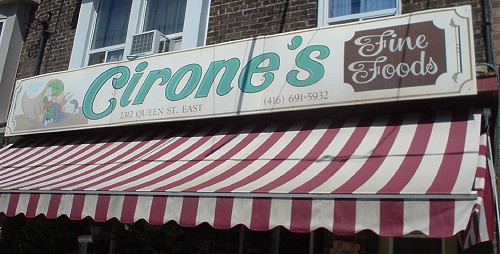 Sign over awning reads Cirone’s (in cursive italic) Fine Foods (in script)