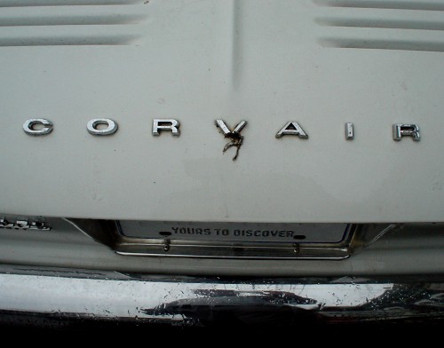 Letters on engine cover read CORVAIR, with YOURS TO DISCOVER on license plate beloow