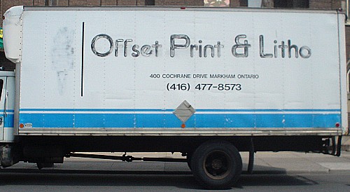 Distressed letters on side of truck resemble pencilled-in architectural handlettering and say Offset Print & Litho