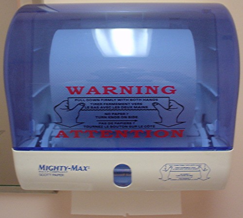 Towel dispenser with bright-blue translucent cover and two sets of instructions