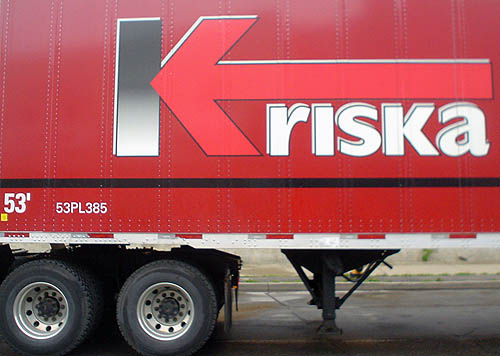 Red truck is emblazoned Kriska in unicase Gill Sans (with an arrow forming the right side of the K)