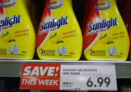 Sign below yellow-and-red bottles of Sunlight Multi-Action says SAVE! THIS WEEK, 6.99, a barcode, and other type