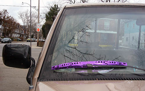 Brown pickup truck with bright purple windshield wiper