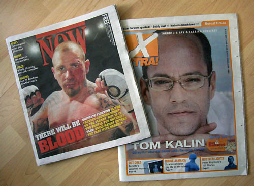 Cover of ‘Now’ featuring bloodied, tattooed, shirtless figher holding up two fists; cover of ‘Xtra’ showing squinting, four-eyed Tom Kalin