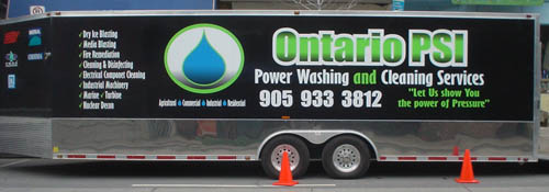Jet-black trailer with chroms accents reads Ontario PSI in green shaded letters and Power Washing and Cleaning Services