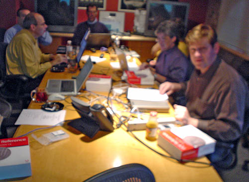 Six people around a wooden conference table, on which sit several copies of ‘PDF Reference 1.6’
