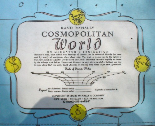 Nameplate on sea-blue atlas background reads RAND McNALLY COSMOPOLITAN WORLD