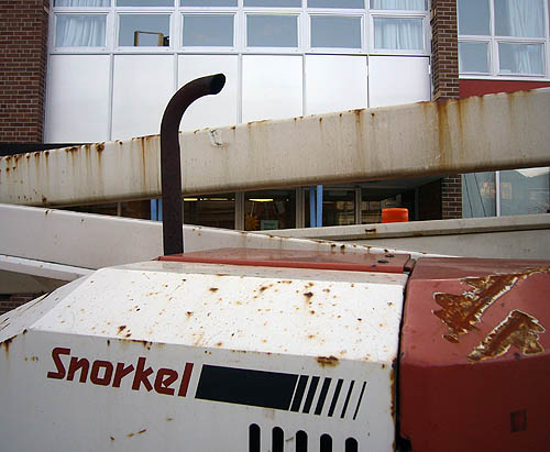 Rusted equipment is labelled Snorkel and has criscrossing ducts and a periscope-like exhaust tube