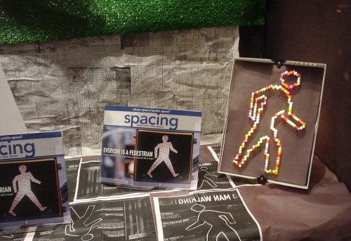 Display shows ‘Spacing’ magazine cover, featuring a pedestrian walk signal, and the same figure made out of Lite-Brite alongside
