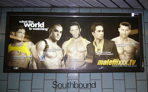 Illuminated ad for Maleflixxx shows scantily-clad male models. It sits above a Soutbound designation on a green tiled wall