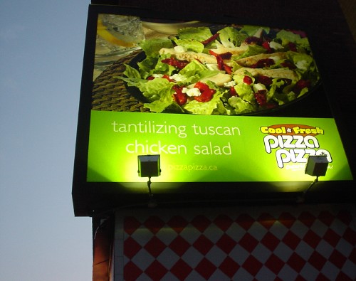 Pizza billboard reads ‘tantilizing tuscan chicken salad’