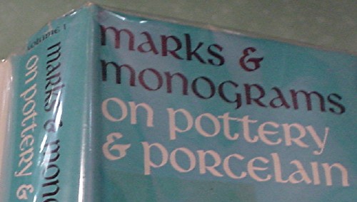 Blue book is entitled ‘Marks & Monograms on Pottery & Porcelain’ in commoncase uncial type