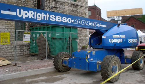 Blue crane is emblazoned UpRight SB80 BOOM LIFT, in part, in sansserif type with high x-height and thick circular strokes