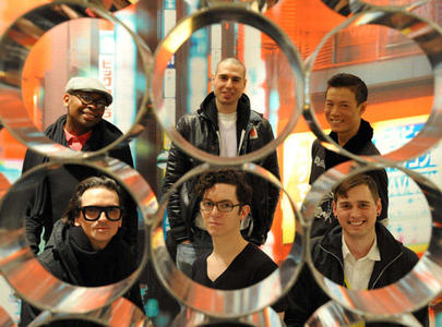 Six guys in black, each seen through a latticework of silver tubes