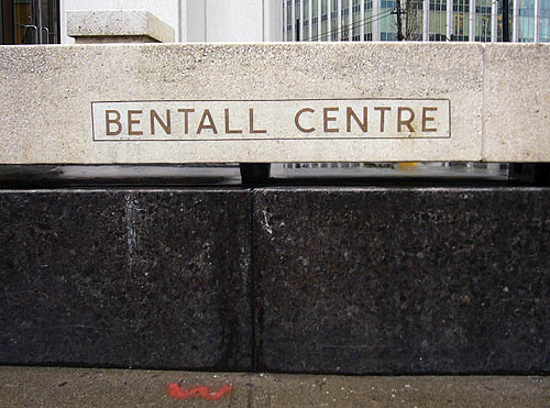 Two-piece retaining wall – concrete on top, deep-black stone beneath – is inscribed BENTALL CENTRE