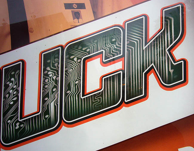 Close-up of sign reads UCK in letters filled in like a circuit board