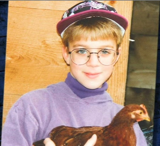 Snyder as boy in glasses with chicken