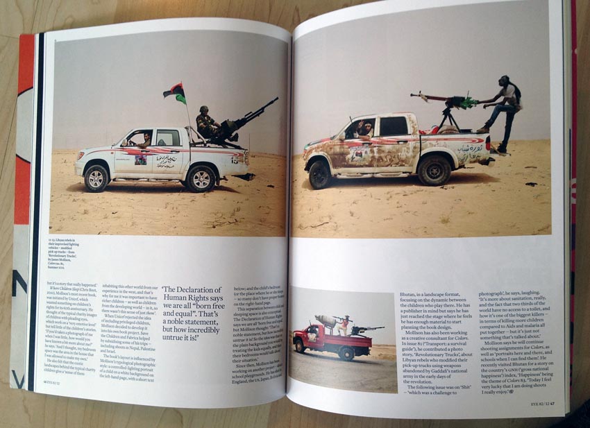 Double-page spread showing African warriors posing with  weapons mounted in the cargo bays of their pickup trucks